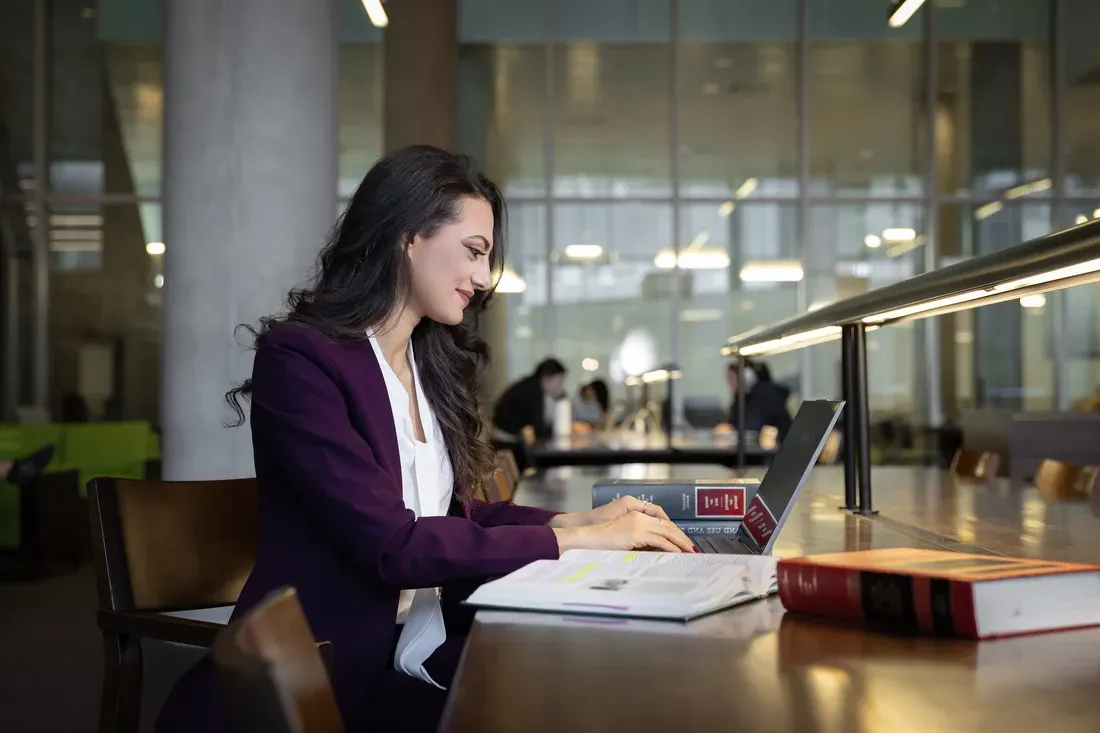 Person working on a computer at the college of law.